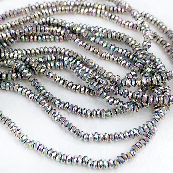 Hematite (button cut) Silver Aurora finish Size: Approx. 1.2 x 2.5 mm Hole diameter: Approx. 0.5 to 0.6 mm