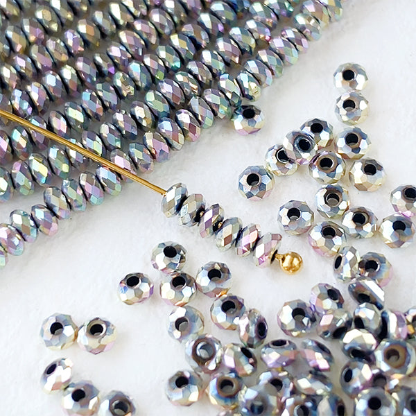 Hematite (button cut) Silver Aurora finish Size: Approx. 1.2 x 2.5 mm Hole diameter: Approx. 0.5 to 0.6 mm